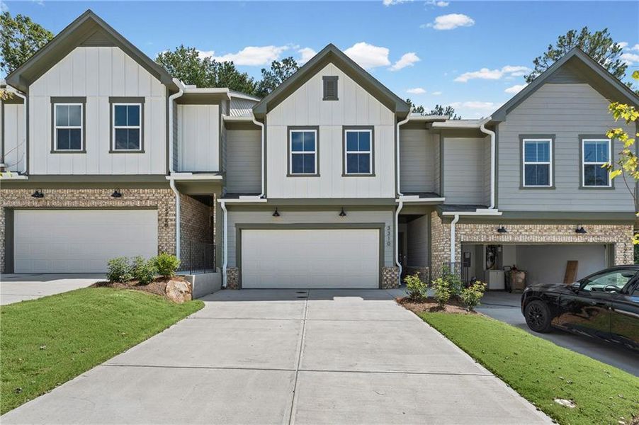 Front exterior of a new home in Ansley Towns, Cumming, GA, highlighting curb appeal (Image 2). Front exterior of a new home in Ansley Towns, Cumming, GA, highlighting curb appeal (Image 2).