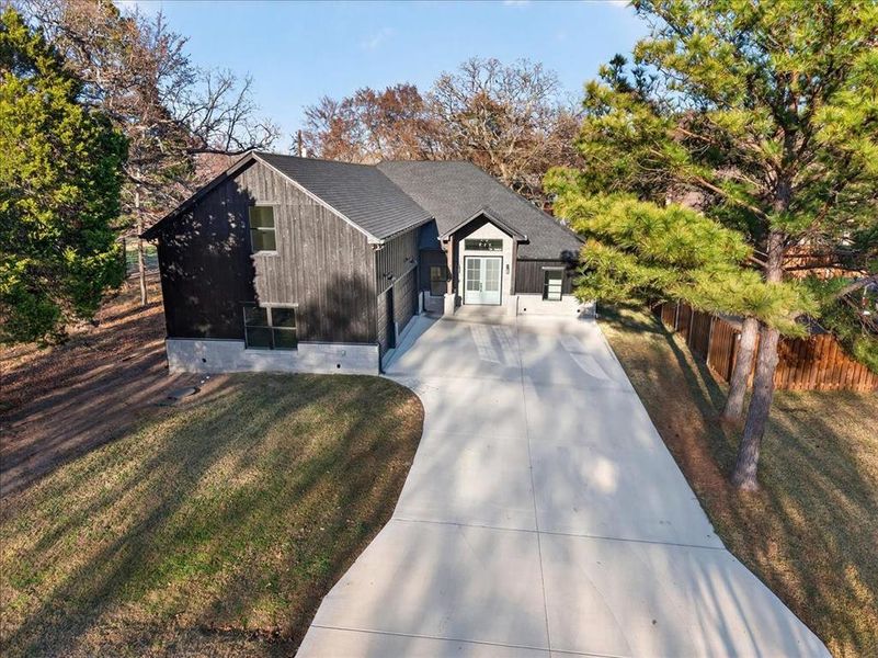 Front exterior of a new home in , Enchanted Oaks, TX, highlighting curb appeal (Image 26).