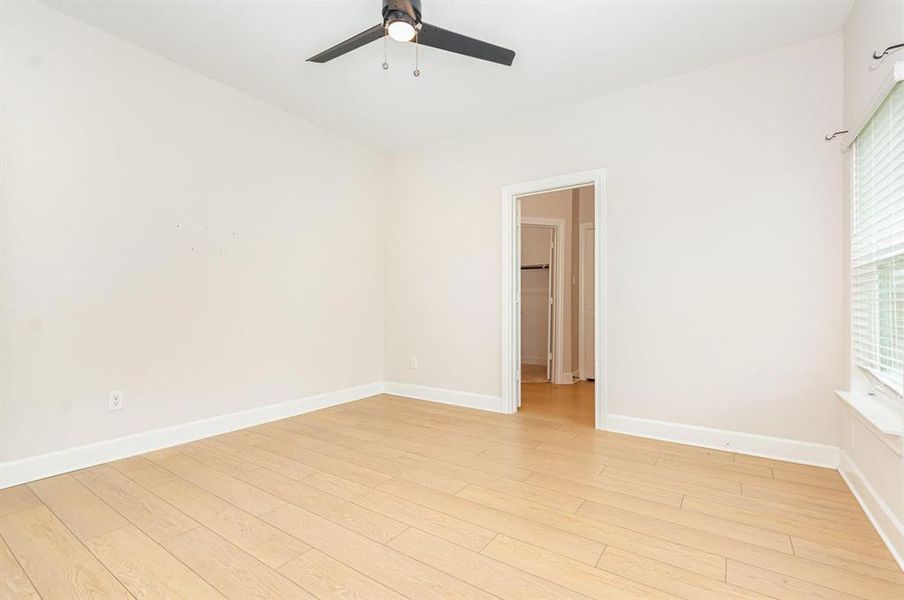 Empty room with light wood-type flooring and ceiling fan Empty room with light wood-type flooring and ceiling fan