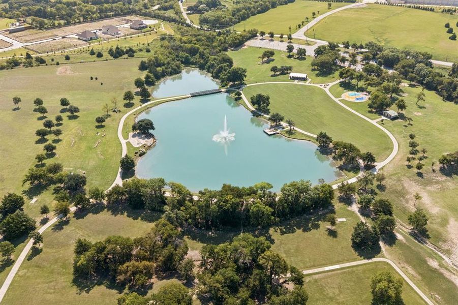 Aerial view of property's location featuring a large body of water and a tree filled landscape Aerial view of property's location featuring a large body of water and a tree filled landscape