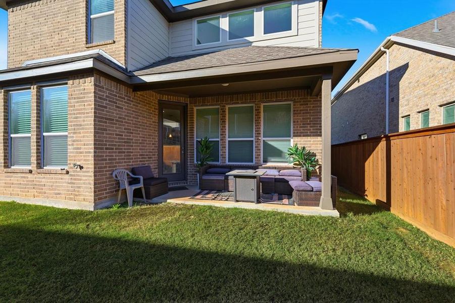 Rear view of house with outdoor lounge area and brick siding
