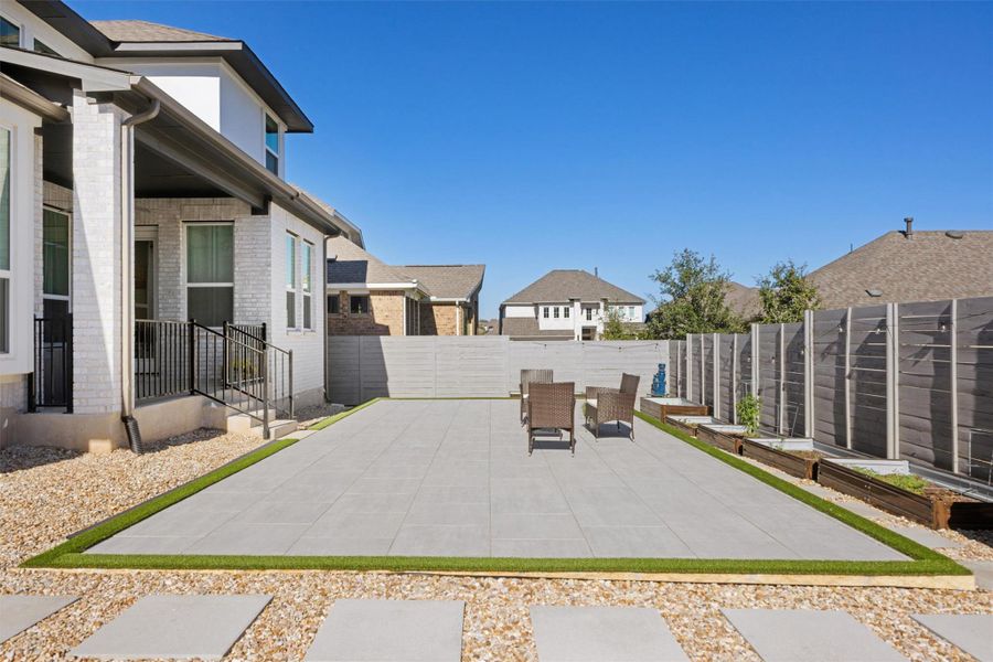 Fenced backyard featuring a patio area and a residential view Fenced backyard featuring a patio area and a residential view