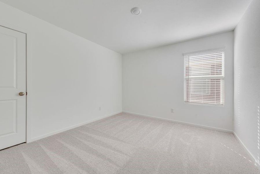 Carpeted empty room with baseboards
