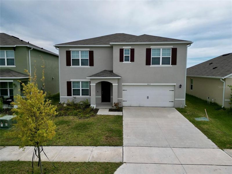 Front exterior of a new home in , Lakeland, FL, highlighting curb appeal (Image 2).
