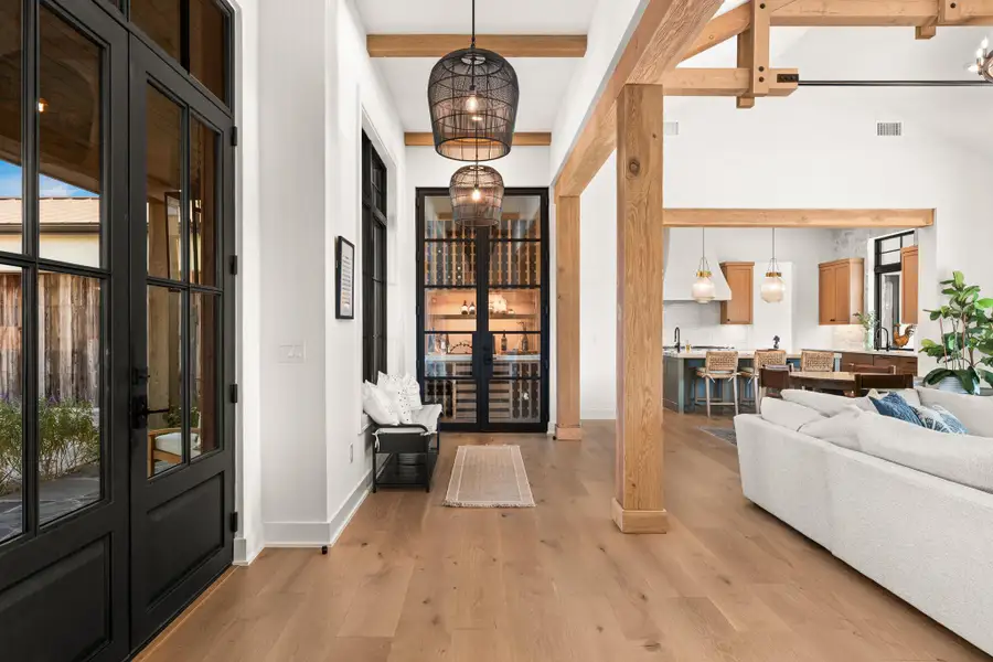 Entrance foyer featuring light wood finished floors, beamed ceiling, and french doors Entrance foyer featuring light wood finished floors, beamed ceiling, and french doors