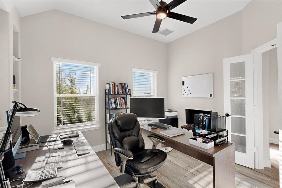 Office space featuring light wood-type flooring and a ceiling fan Office space featuring light wood-type flooring and a ceiling fan
