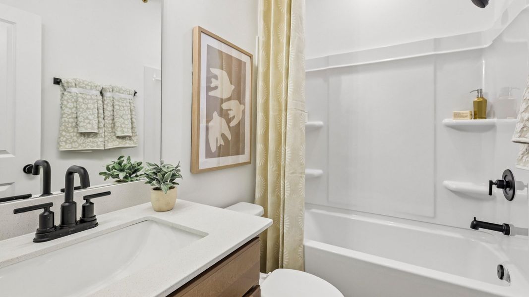 Bathroom with single vanity, toilet, and shower Bathroom with single vanity, toilet, and shower