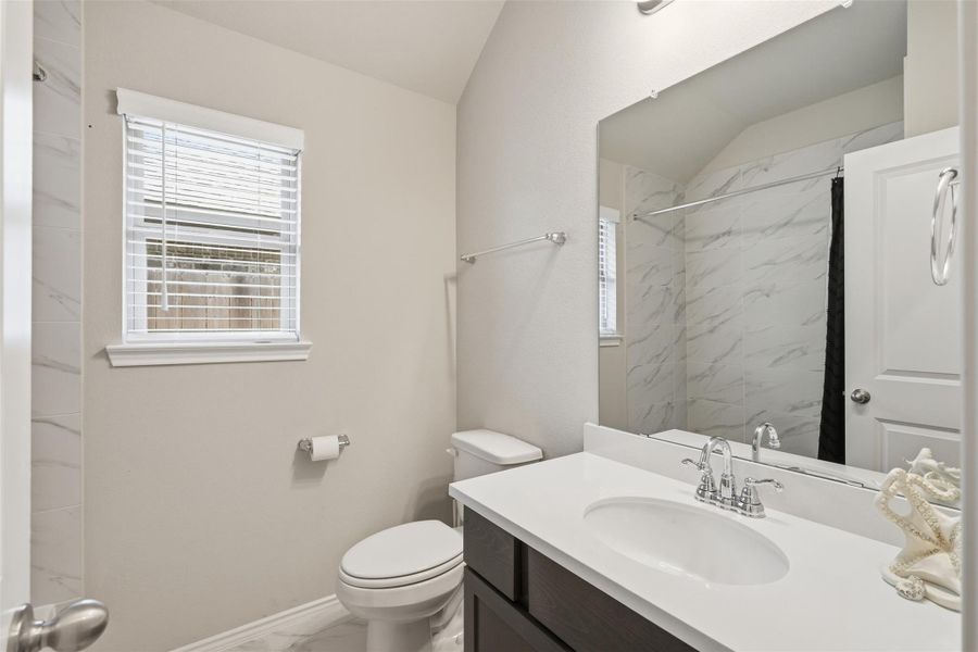 Beautifully finished secondary bath with quartz countertops and a tiled tub/shower surround. Beautifully finished secondary bath with quartz countertops and a tiled tub/shower surround.