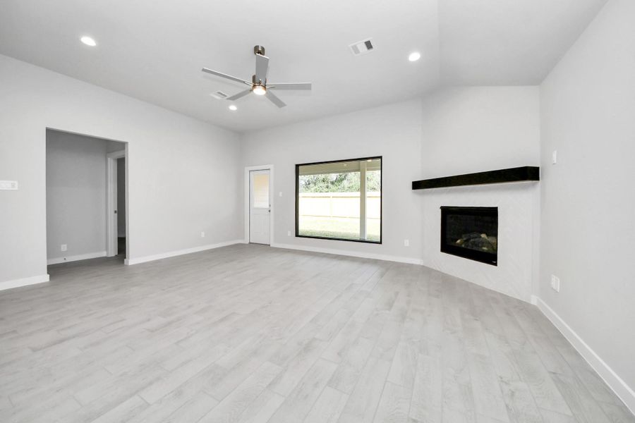 Family room flooded with natural light through the expansive windows. The premium tile flooring adds a touch of luxury to the space, creating the perfect setting for relaxing moments and cherished gatherings with loved ones. Sample photo of completed home with similar floor plan. Actual colors and selections may vary. Family room flooded with natural light through the expansive windows. The premium tile flooring adds a touch of luxury to the space, creating the perfect setting for relaxing moments and cherished gatherings with loved ones. Sample photo of completed home with similar floor plan. Actual colors and selections may vary.