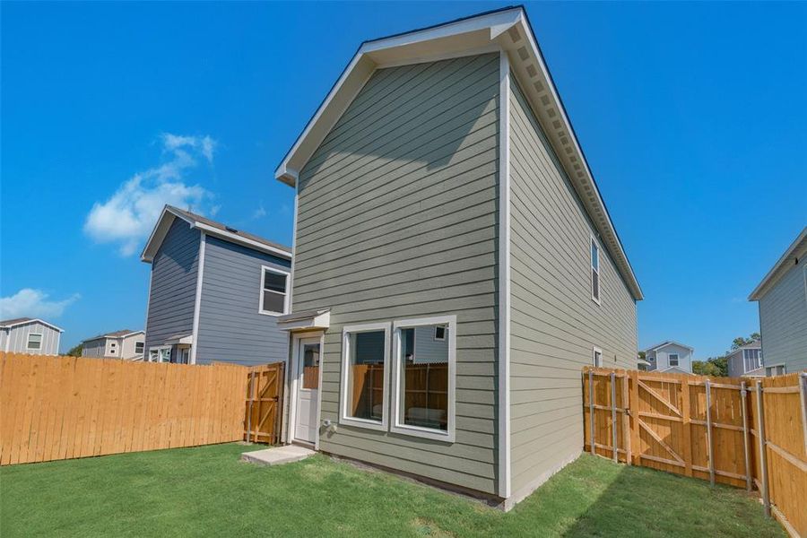 Rear view of house featuring a yard