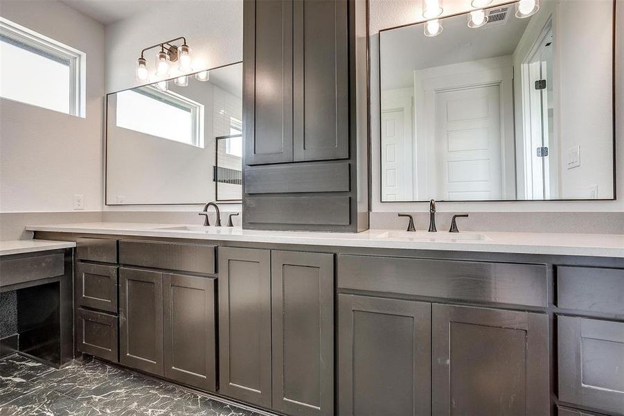 Bathroom featuring tile patterned flooring and double vanity