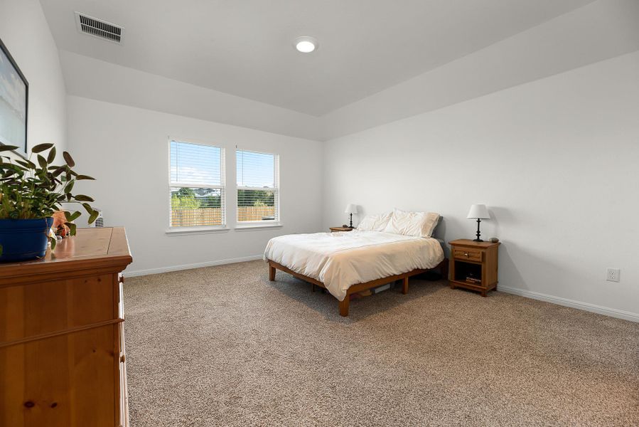 Bedroom with baseboards and carpet flooring