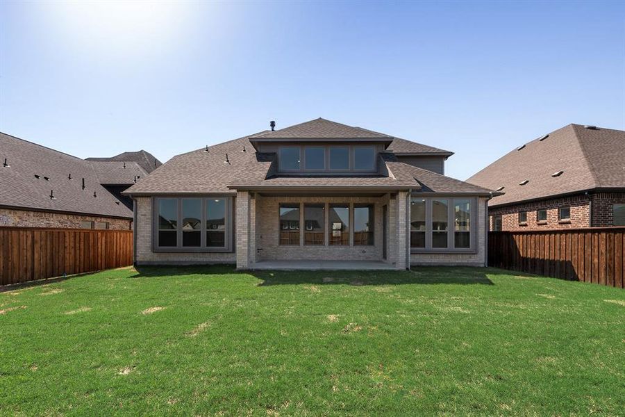 Back of house featuring a shingled roof, a fenced backyard, and a patio Back of house featuring a shingled roof, a fenced backyard, and a patio