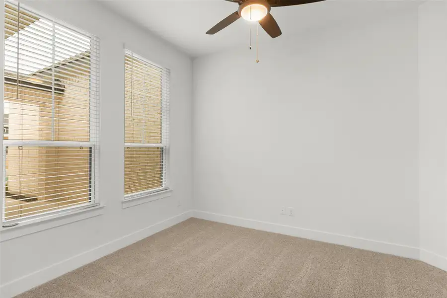 Spare room with light colored carpet and ceiling fan Spare room with light colored carpet and ceiling fan