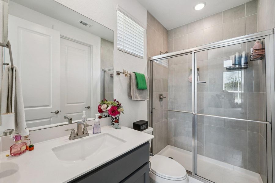 Each guest bathroom is beautifully finished with modern fixtures and a clean, elegant design.