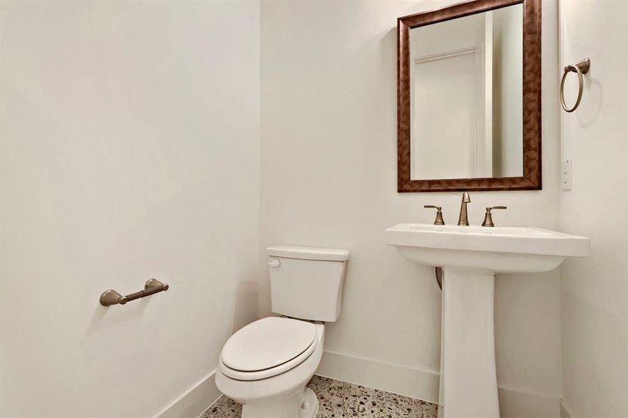 Bathroom with toilet and baseboards
