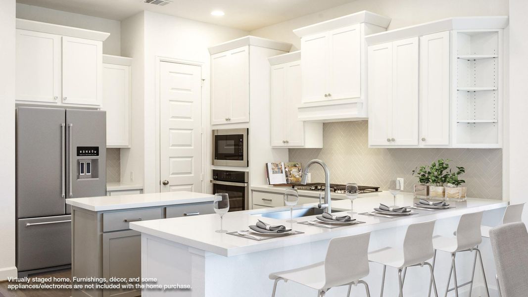 Kitchen with open shelves, white cabinets, a breakfast bar, backsplash, and stainless steel appliances Kitchen with open shelves, white cabinets, a breakfast bar, backsplash, and stainless steel appliances