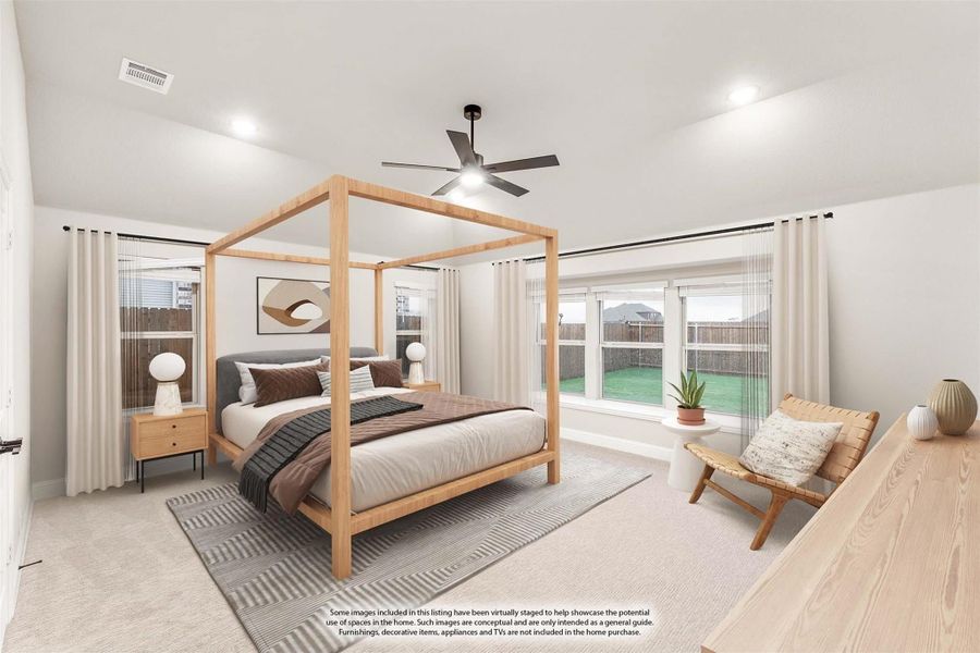 Spacious master bedroom with wood four-poster bed, ceiling fan, and large windows overlooking backyard