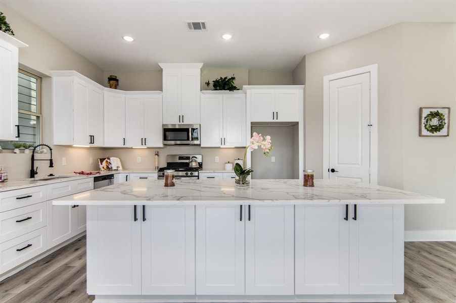 Entertain at this large island which can accommodate 4 barstools. There's more cabinets under the island.