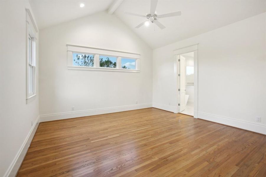 Another shot of the primary bedroom leading into the primary bathroom.