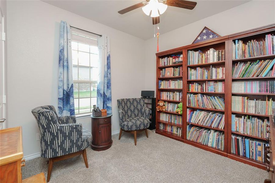 Living area with carpet floors and ceiling fan