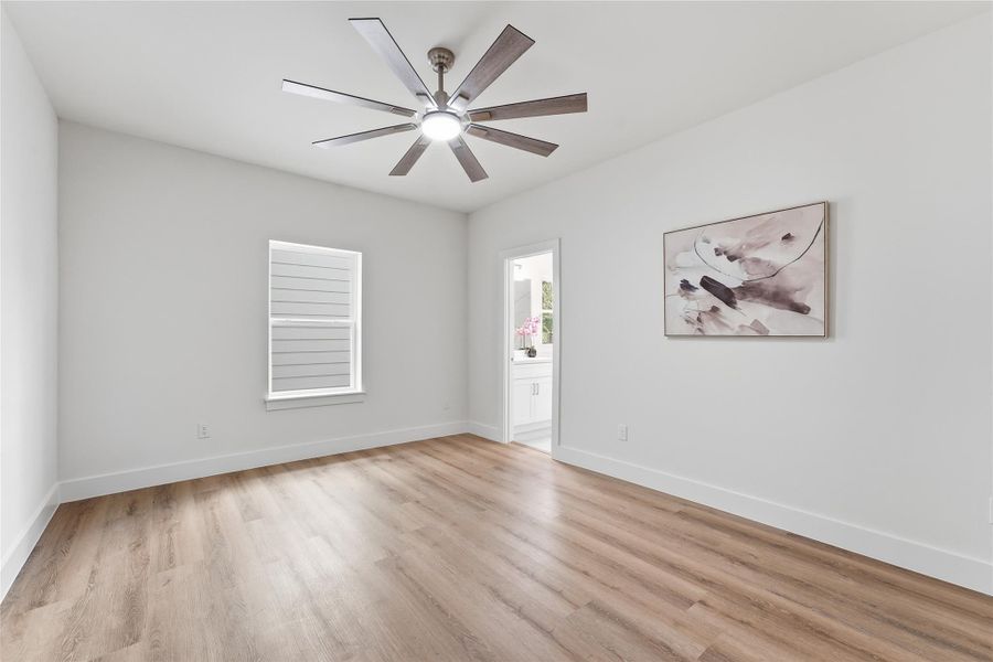 Well-sized second-floor secondary bedroom with wood-look flooring, natural light, and convenient access to a full bath Well-sized second-floor secondary bedroom with wood-look flooring, natural light, and convenient access to a full bath