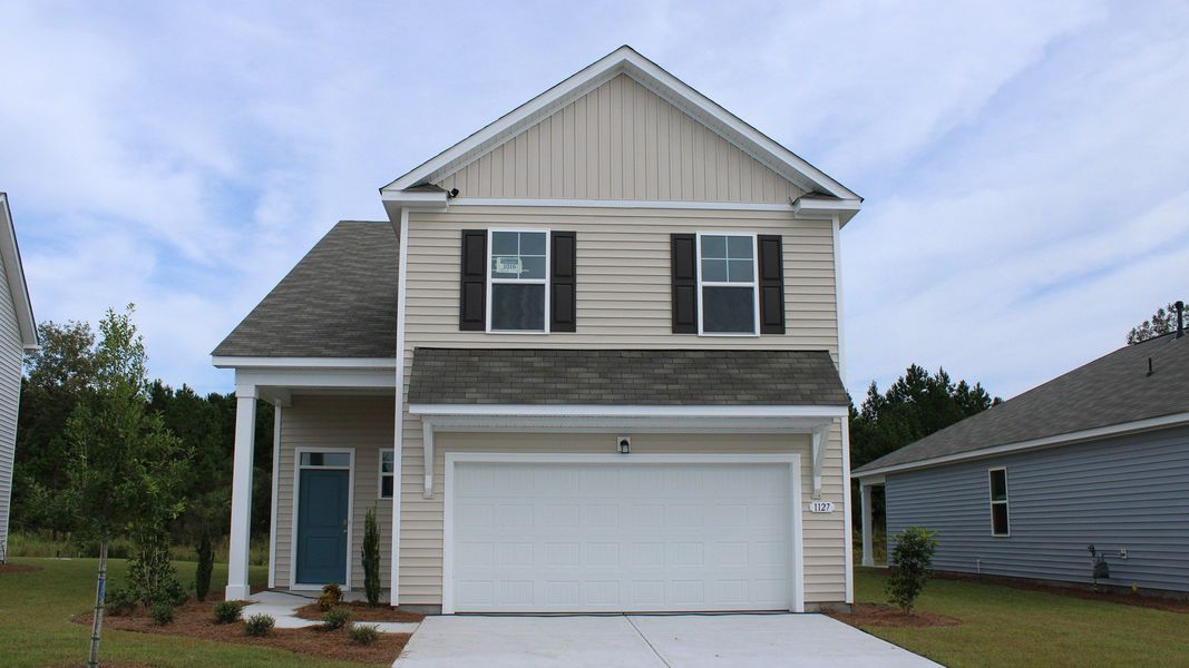 Front exterior of a new home in The Reserve at Wild Horse, Conway, SC, highlighting curb appeal (Image 1).