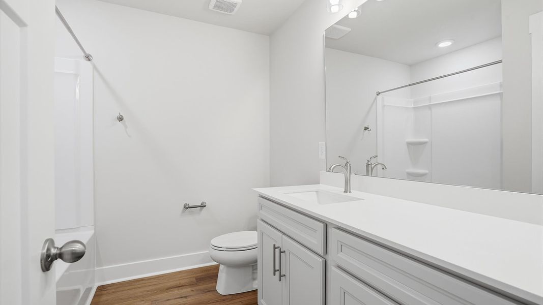Notable full bathroom offering tasteful details and a bright, functional space by DRB Homes Notable full bathroom offering tasteful details and a bright, functional space by DRB Homes