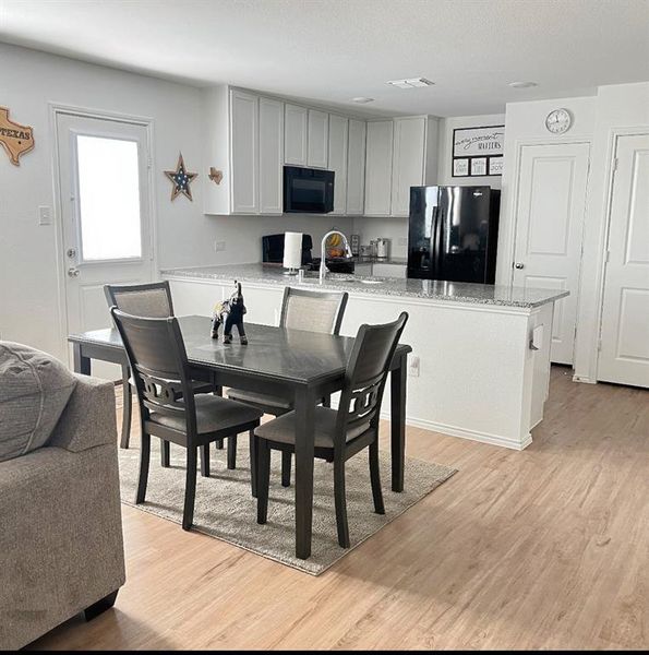 Dining area with light wood-type flooring Dining area with light wood-type flooring