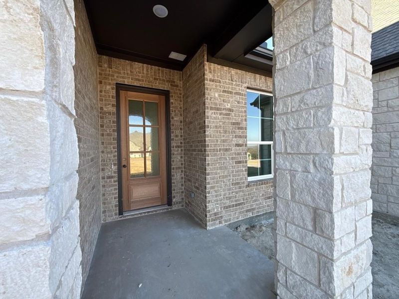Entrance to property with brick siding