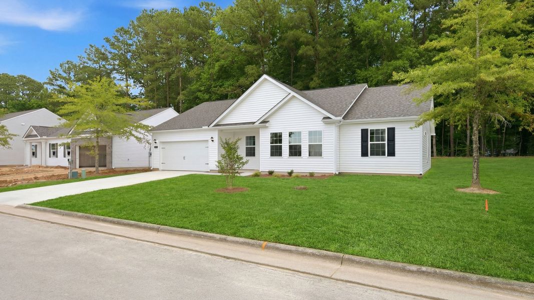 Front exterior of a new home in Tyler - Home on the Lake, New Bern, NC, highlighting curb appeal (Image 17).