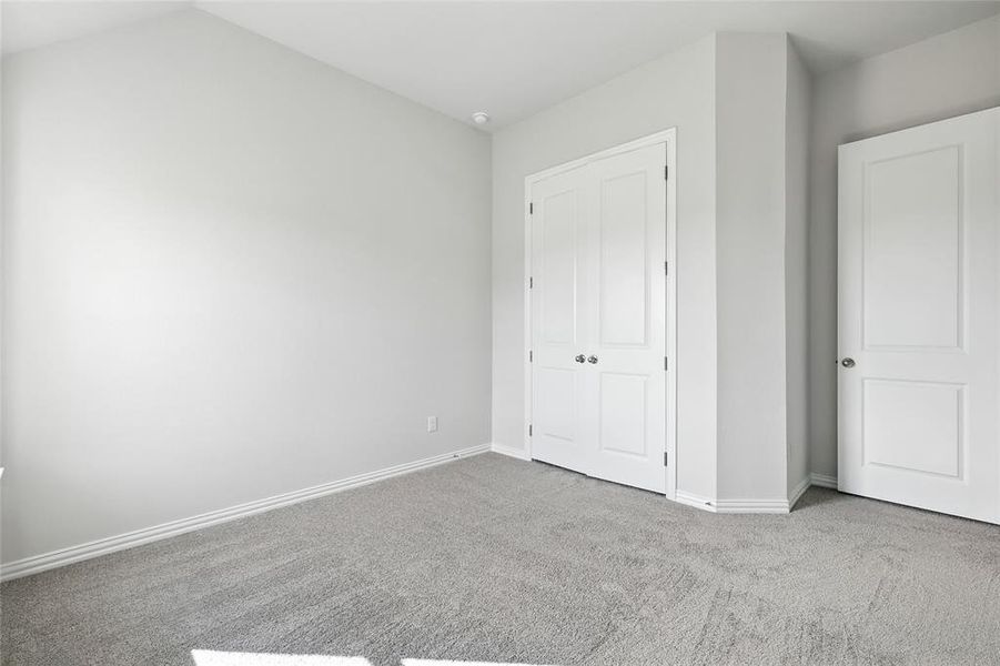 Unfurnished bedroom featuring carpet flooring and baseboards Unfurnished bedroom featuring carpet flooring and baseboards