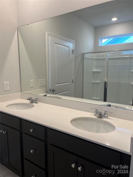 The Primary bath features dual vanities, stand up shower and large walk in closet