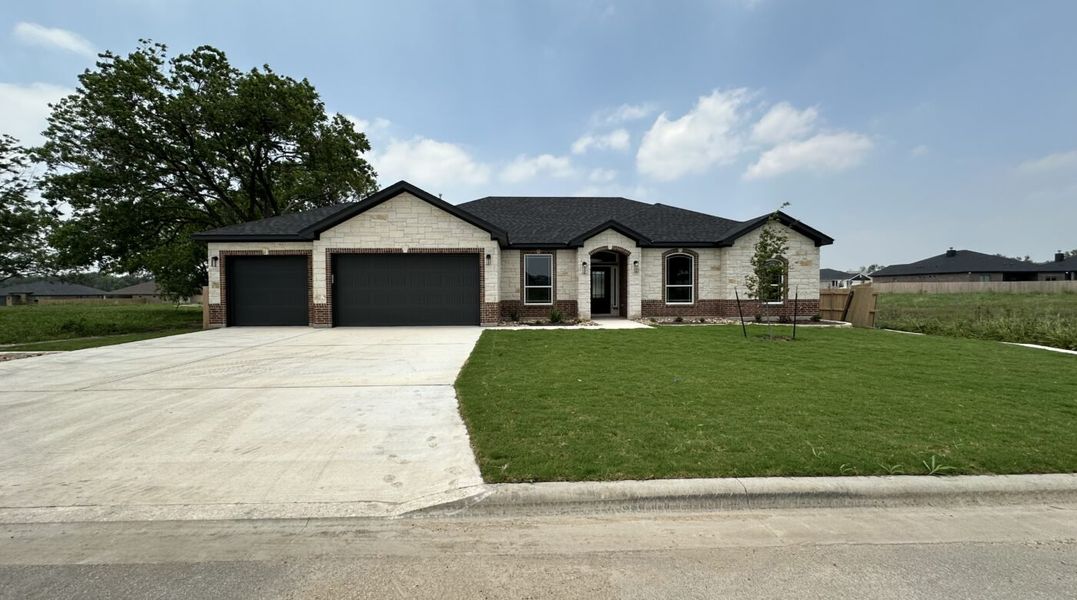 Representative exterior photo of a completed home built from the Nixon 3 car by Carothers Executive Homes in Eagle Heights, Salado, TX (Image 1). Representative exterior photo of a completed home built from the Nixon 3 car by Carothers Executive Homes in Eagle Heights, Salado, TX (Image 1).