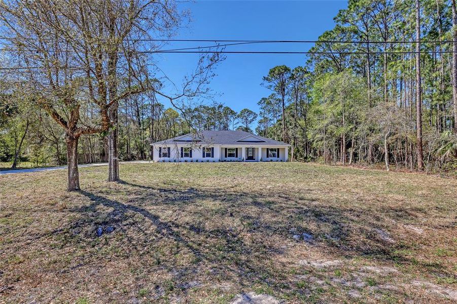 Front exterior of a new home in , Mims, FL, highlighting curb appeal (Image 27).