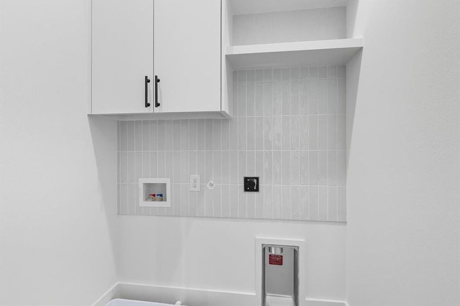 Laundry room with washer hookup, hookup for an electric dryer, and cabinet space Laundry room with washer hookup, hookup for an electric dryer, and cabinet space