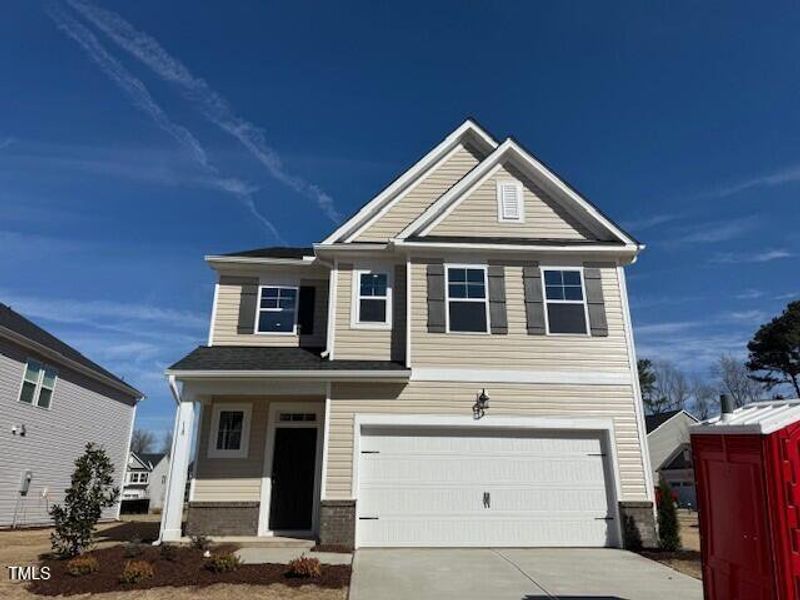 Front exterior of a new home in Gregory Village, Lillington, NC, highlighting curb appeal (Image 10). Front exterior of a new home in Gregory Village, Lillington, NC, highlighting curb appeal (Image 10).
