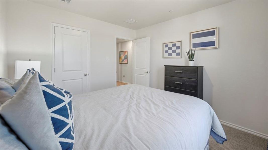 Bedroom with baseboards and light carpet Bedroom with baseboards and light carpet