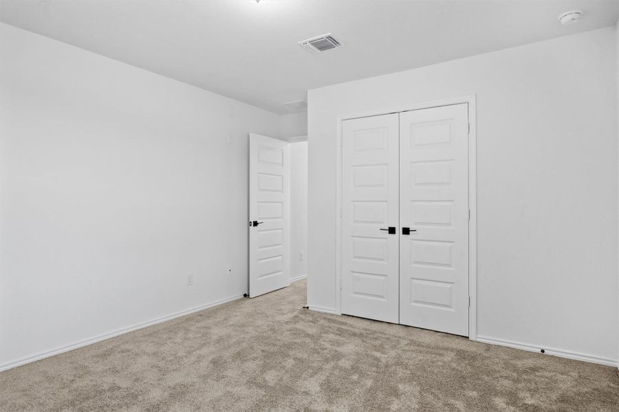 Unfurnished bedroom featuring carpet floors and a closet