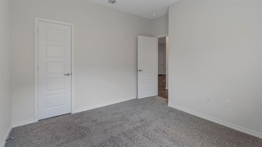 Unfurnished bedroom featuring baseboards and carpet floors Unfurnished bedroom featuring baseboards and carpet floors