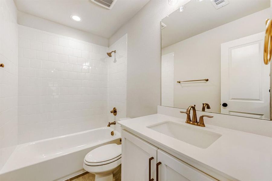 Full bath with vanity, bathing tub / shower combination, and recessed lighting