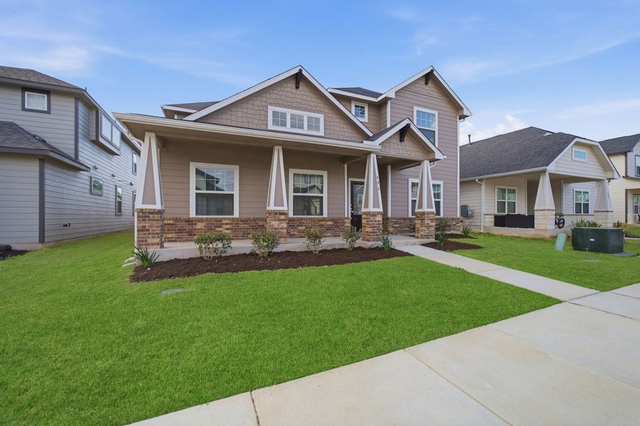 Front exterior of a new home in Brooklands, Hutto, TX, highlighting curb appeal (Image 27). Front exterior of a new home in Brooklands, Hutto, TX, highlighting curb appeal (Image 27).