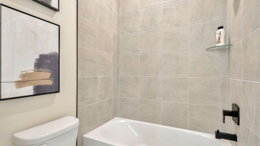 The Jack and Jill Bathroom of a DRB Homes Grand Eider model, which is a home plan offered at Serengeti in Spring Hill, FL.