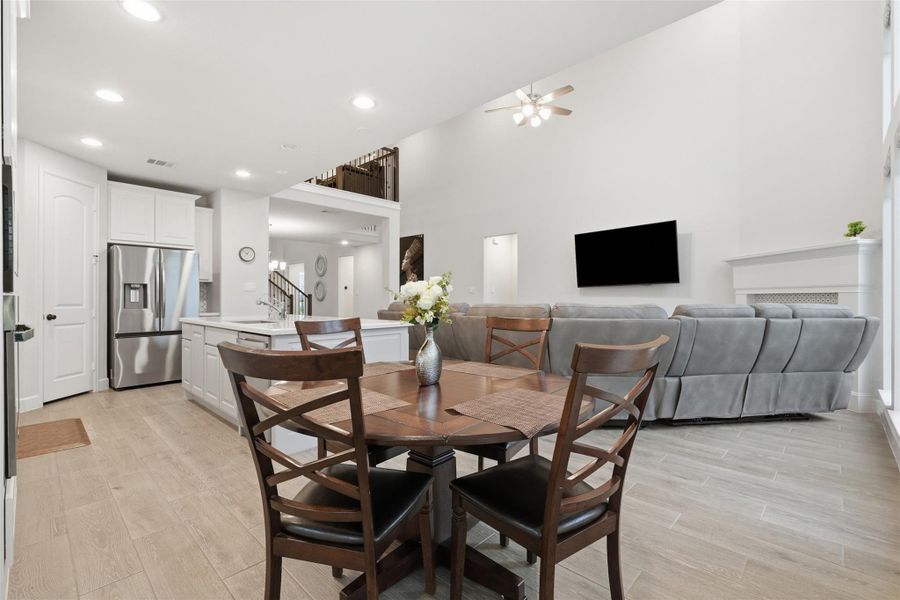 This open-concept living space features a modern kitchen with stainless steel appliances, a cozy dining area, and a spacious living room with high ceilings and abundant natural light. Perfect for entertaining and family gatherings. This open-concept living space features a modern kitchen with stainless steel appliances, a cozy dining area, and a spacious living room with high ceilings and abundant natural light. Perfect for entertaining and family gatherings.