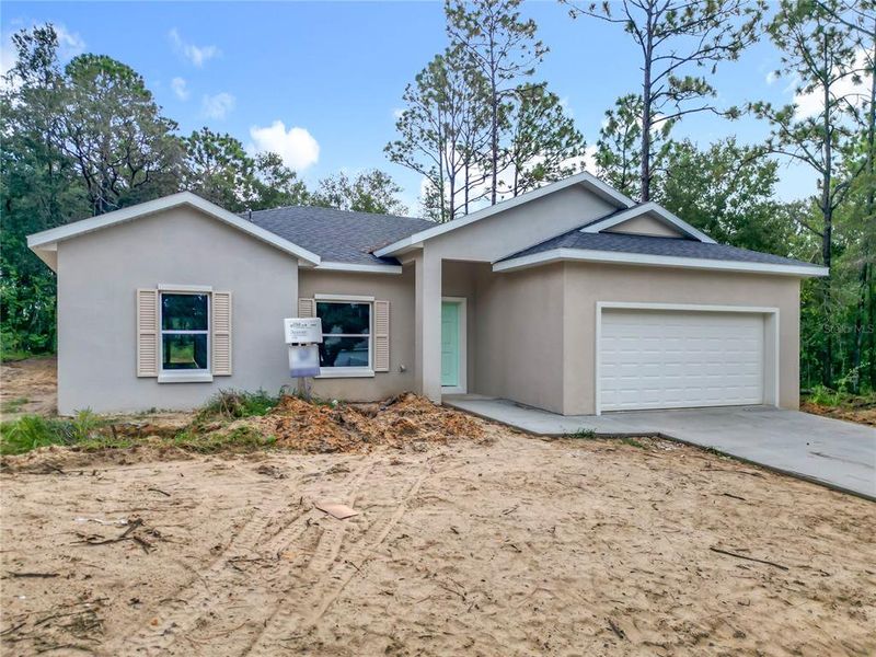 Front exterior of a new home in , Citrus Springs, FL, highlighting curb appeal (Image 14). Front exterior of a new home in , Citrus Springs, FL, highlighting curb appeal (Image 14).