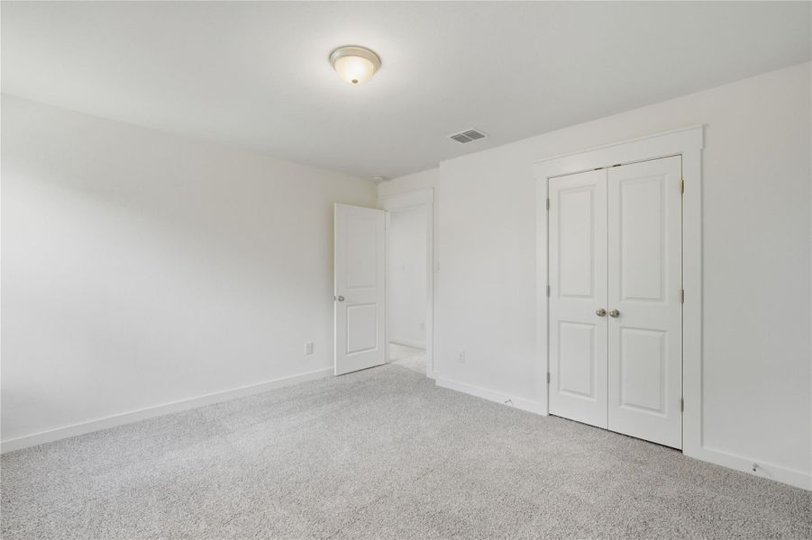 Unfurnished bedroom featuring carpet flooring and a closet Unfurnished bedroom featuring carpet flooring and a closet