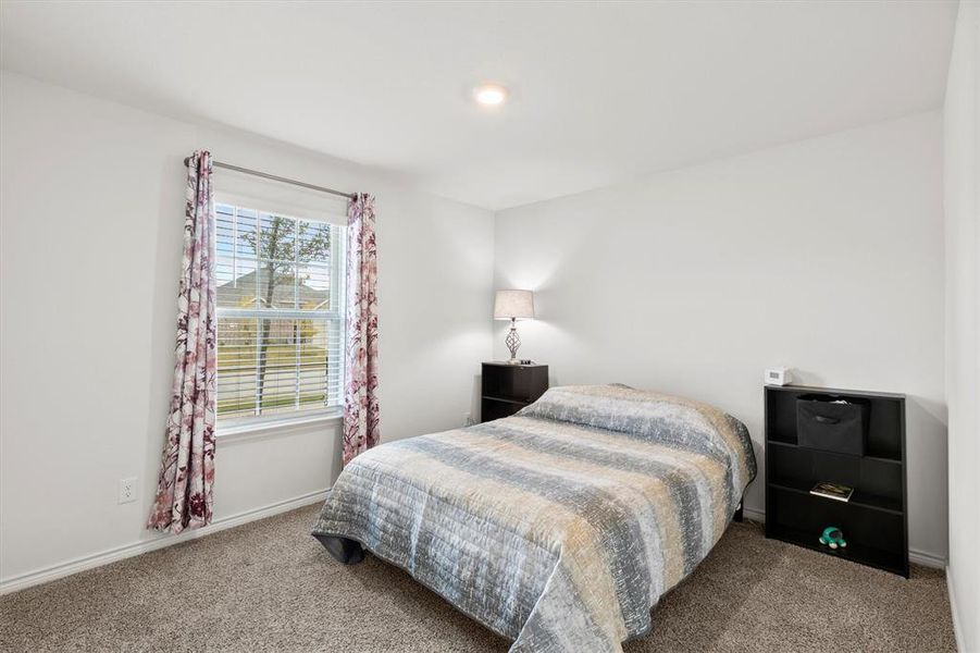 Bedroom with carpet floors and baseboards