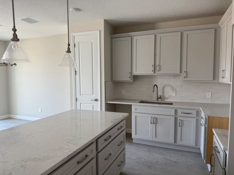 Foyer leads into elegant kitchen featuring the AW Milan Collection Foyer leads into elegant kitchen featuring the AW Milan Collection