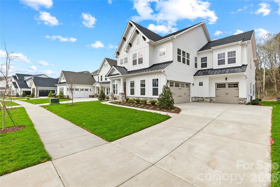 Front exterior of a new home in , Huntersville, NC, highlighting curb appeal (Image 18).