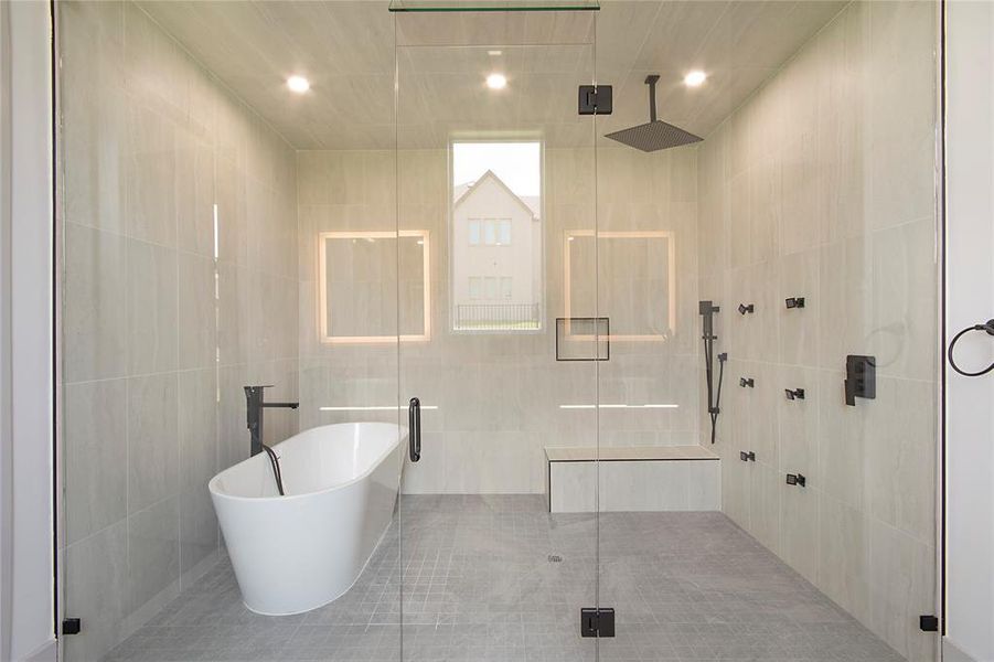 Bathroom with a shower stall, tile walls, a soaking tub, and recessed lighting